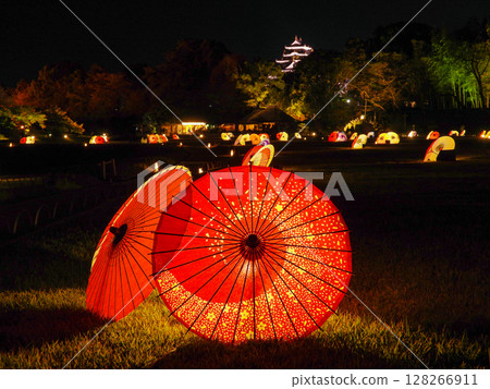 Illuminated Japanese umbrellas and Okayama Castle tower Illuminated Japanese umbrellas and Okayama Castle tower 128266911