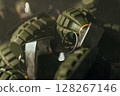 A bunch of metal hand grenades laying in box 128267146