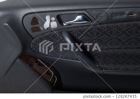 Car interior. Front handle door panel. Car open door window buttons. Spare parts for repair and restoration Car interior. Front handle door panel. Car open door window buttons. Spare parts for repair and restoration 128267435