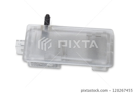 spare part from the car on a white isolated background is a cover for the illumination of a standard sign on the trunk lid for replacement and repair. Spare parts catalog. spare part from the car on a white isolated background is a cover for the illumination of a standard sign on the trunk lid for replacement and repair. Spare parts catalog. 128267455