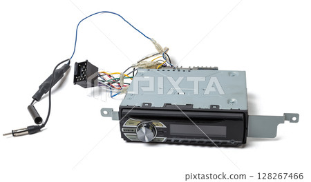 an audio system 1din and a radio in gray and black plastic of car with cd and mp3 music on white isolated background an audio system 1din and a radio in gray and black plastic of car with cd and mp3 music on white isolated background 128267466