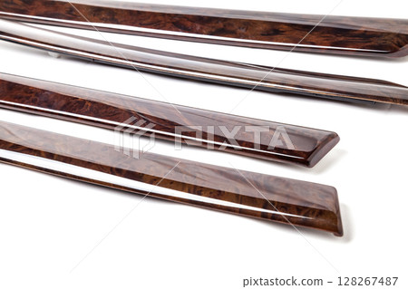 decorative overlay of the panel and doors of the car interior from the root of the walnut tree in brown color. decorative overlay of the panel and doors of the car interior from the root of the walnut tree in brown color. 128267487