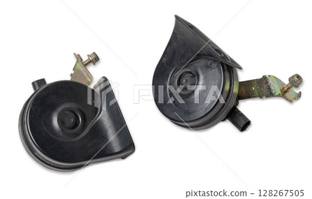 Pair of electric black plastic horns in retro style - car horn on white isolated background in photo studio. Spare part for sale or repair in a workshop, or tuning a buzzer sound in car service. Pair of electric black plastic horns in retro style - car horn on white isolated background in photo studio. Spare part for sale or repair in a workshop, or tuning a buzzer sound in car service. 128267505