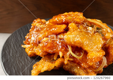 Sweet and Crispy Guo Bao Rou with Vegetables on Black Plate 128267960