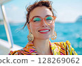 Stylish woman enjoying sun on yacht, smiling with eyes closed 128269062