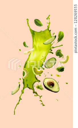 Hand made collage. Avocado and green vegetables in motion with vibrant green splash Hand made collage. Avocado and green vegetables in motion with vibrant green splash 128269555