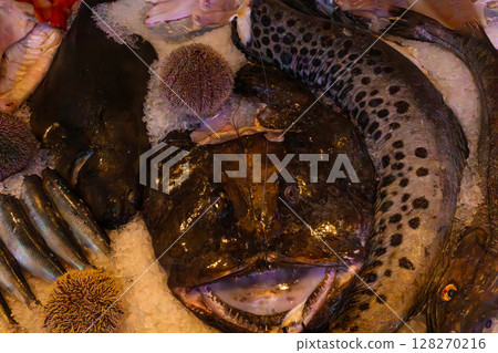 Anglerfish and fresh seafood on crushed ice at Bergen Norway national fish market display 128270216