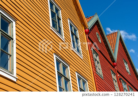 Colorful wooden house facades in Bryggen Bergen Norway against deep blue summer sky 128270241