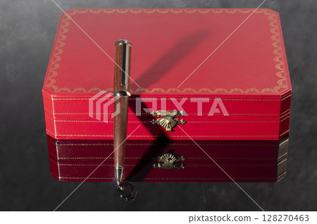 Branded pen with cufflinks and business card holder in a box. Gift set. Office interior. Branded pen with cufflinks and business card holder in a box. Gift set. Office interior. 128270463
