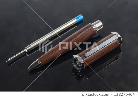 Branded pen with cufflinks and business card holder in a box. Gift set. Office interior. 128270464