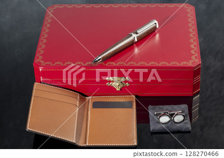 Branded pen with cufflinks and business card holder in a box. Gift set. Office interior. 128270466