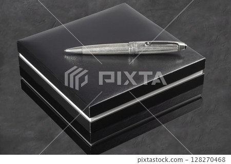 Branded pen with cufflinks and business card holder in a box. Gift set. Office interior. Branded pen with cufflinks and business card holder in a box. Gift set. Office interior. 128270468