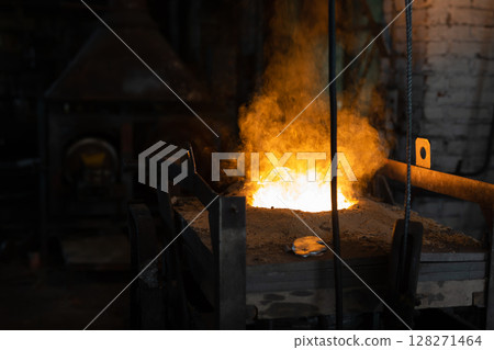 Ferrous metal billet is melted in an induction furnace closeup Ferrous metal billet is melted in an induction furnace closeup 128271464