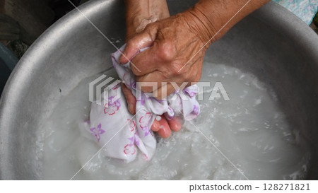 Handwash laundry by wrinkled hands of old woman 128271821