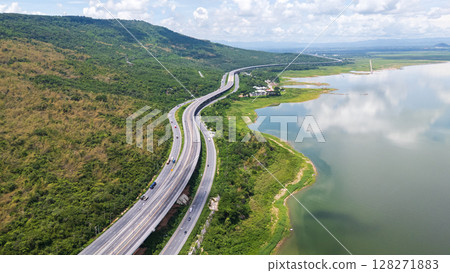 Drone shot The M6 motorway Nakhon Ratchasima Province - Bang Pa-in Lam Ta Khong River and Mountain. Motorway Korat Thailand Drone shot The M6 motorway Nakhon Ratchasima Province - Bang Pa-in Lam Ta Khong River and Mountain. Motorway Korat Thailand 128271883