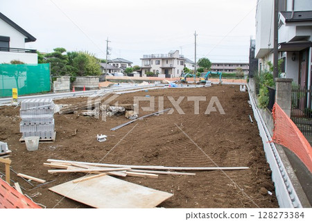 Preparation for foundation work and materials are placed on the vacant lot Construction begins Preparation for foundation work and materials are placed on the vacant lot Construction begins 128273384