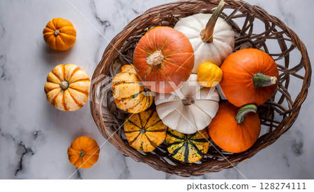large pumpkins and pumpkins piled up in a basket on white marble top view large pumpkins and pumpkins piled up in a basket on white marble top view 128274111