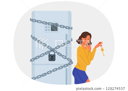 Woman starting diet locked refrigerator to reduce number of calories from food consumed Woman starting diet locked refrigerator to reduce number of calories from food consumed 128274537