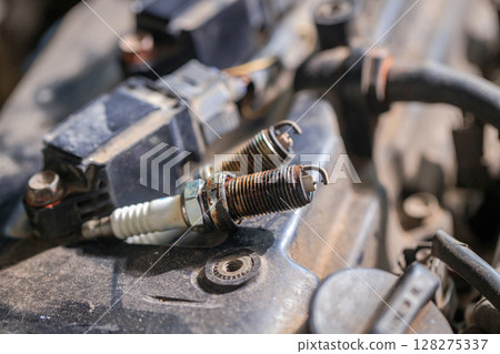 Spark plugs for gasoline engines that are old and have expired will cause incomplete combustion in the engine, in soot and dirt. Changing spark plugs can maintain and extend the life of the engine 128275337