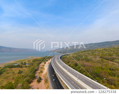 The M6  motorway Expressway Nakhon Ratchasima Province - Bang Pa-in. Lam Ta Khong River and Mountain. Drone shot of scenic landscape rural place traffic. Nakhon Ratchasima Thailand. Motorway Korat 128275338