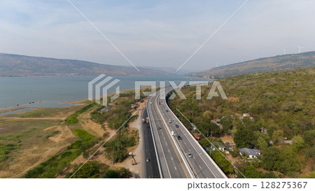 The M6  motorway Expressway Nakhon Ratchasima Province - Bang Pa-in. Lam Ta Khong River and Mountain. Drone shot of scenic landscape rural place traffic. Nakhon Ratchasima Thailand. Motorway Korat 128275367