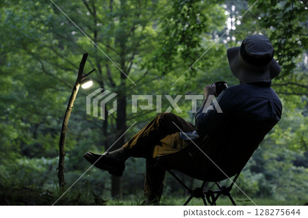 A man enjoying the quiet sunset at a solo camp A man enjoying the quiet sunset at a solo camp 128275644