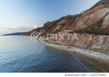 Rocky, pebble and clayey banks of the Kama River. Mountain slope of various rock types. 128275645