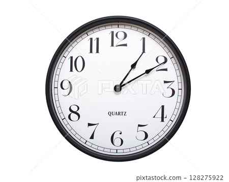 Round analog wall clock with a black frame, white face, and bold black numerals. showing 01:10 or 13:10. Isolated on a white background. Ideal for time-related themes. Round analog wall clock with a black frame, white face, and bold black numerals. showing 01:10 or 13:10. Isolated on a white background. Ideal for time-related themes. 128275922