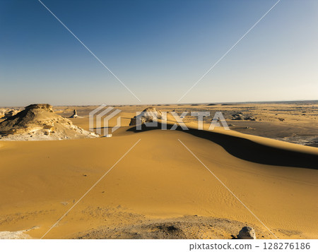 White rock formations and sand dunes in Egypt's White Desert, natural desert landscape 128276186