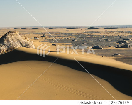 White rock formations and sand dunes in Egypt's White Desert, natural desert landscape 128276189