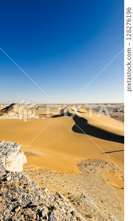 White rock formations and sand dunes in Egypt's White Desert, natural desert landscape 128276196