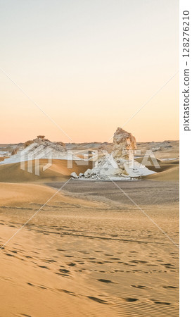 White rock formations and sand dunes in Egypt's White Desert, natural desert landscape 128276210