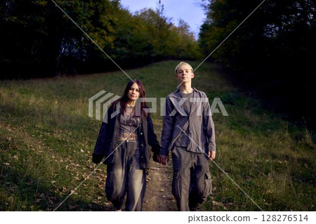 two 15-year-old teenagers in love play, hug, spend time together in an autumn park two 15-year-old teenagers in love play, hug, spend time together in an autumn park 128276514