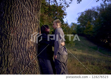two 15-year-old teenagers in love under old majestic oak in an autumn park two 15-year-old teenagers in love under old majestic oak in an autumn park 128276523