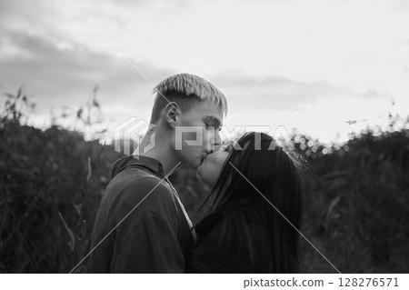 A 15-year-old teenage couple in love hugs and kisses at sunset A 15-year-old teenage couple in love hugs and kisses at sunset 128276571