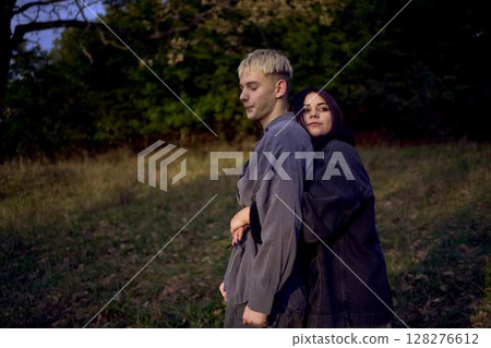 two 15-year-old teenagers in love play, hug, spend time together in an autumn park two 15-year-old teenagers in love play, hug, spend time together in an autumn park 128276612