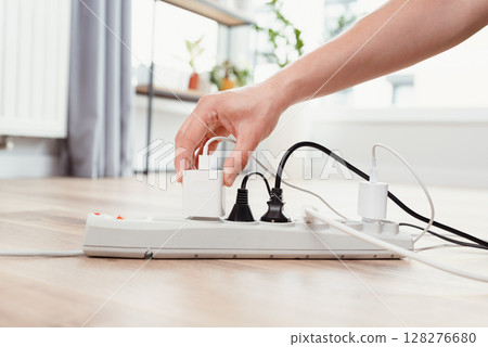 Power strip socket with connected plugs. 128276680