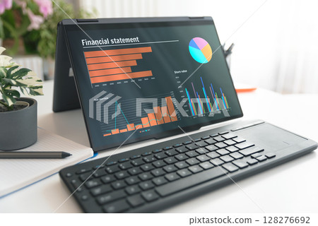 Laptop 2 in 1 with financial data sheet on screen 128276692