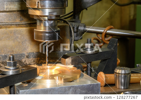 The drilling process the brass material plate on NC milling machine. The drilling process the brass material plate on NC milling machine. 128277267