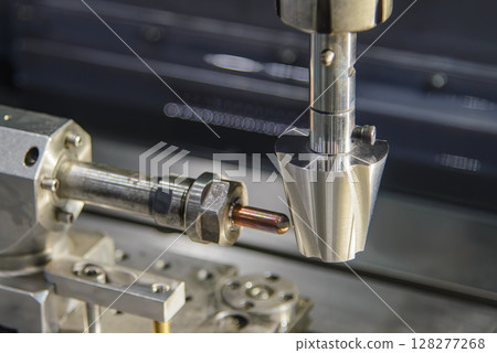 The sinker EDM machine operation with the copper electrode. 128277268
