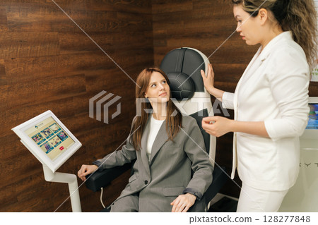Female medical specialist discussing pelvic floor muscle training, providing professional guidance while patient sitting on chair during consultation. Concept of innovative healthcare technology. Female medical specialist discussing pelvic floor muscle training, providing professional guidance while patient sitting on chair during consultation. Concept of innovative healthcare technology. 128277848