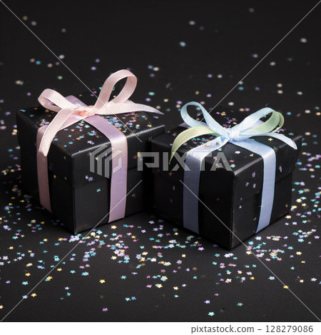 Black Gift Boxes with Pastel Ribbons and Confetti on Dark Background Black Gift Boxes with Pastel Ribbons and Confetti on Dark Background 128279086