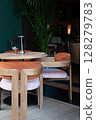 A Stylish and Contemporary Restaurant Interior Featuring Modern Furniture and Green Accents 128279783