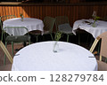 Charming Outdoor Caf Setting with Green Chairs 128279784