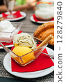 Croissant with pistachio and mango scoops of gelato in italian cafe 128279840