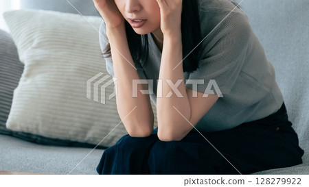 一個憂心忡忡的女人抱著頭 128279922