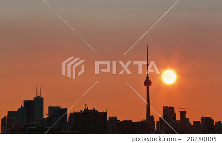 Toronto's skyline lit by sun raising behind the buildings Toronto's skyline lit by sun raising behind the buildings 128280005