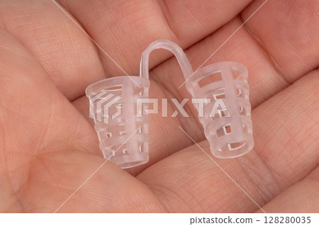 Anti snoring silicone nose clip held in hand 128280035