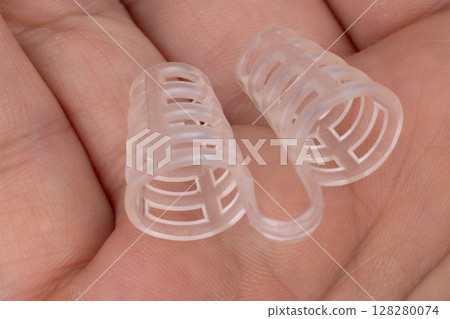 Silicone nasal anti snoring clip in hand Silicone nasal anti snoring clip in hand 128280074