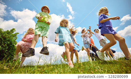 Jump squad. Cheerful kids enjoying themselves outside on a sunny day Jump squad. Cheerful kids enjoying themselves outside on a sunny day 128280099